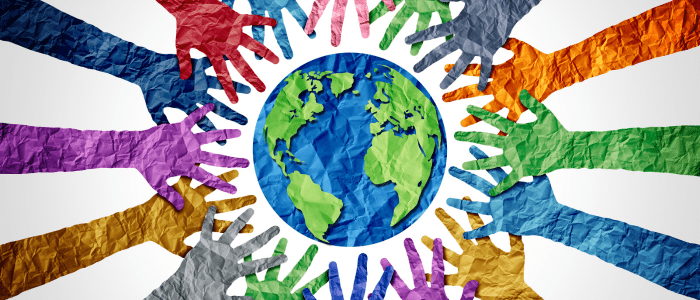 An image of the world made out of paper, surrounded by paper cut outs of hands in various colours. To represent that the FDA releases draft guidance to enhance diversity in clinical trials.