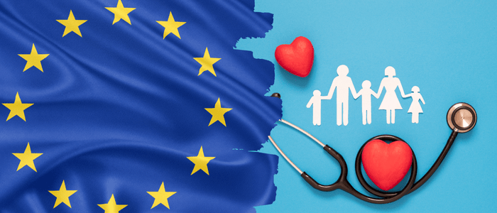 An EU flag over a light blue background, next to a stethoscope wrapped around an image of a red heart. 3 stick figure children cut out of paper are holding hands with two stick figure adults. Above them is another red heart. To represent that stakeholders call for updated ATMP methodologies for JCA.