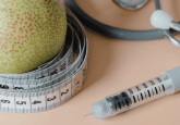 A tape measure wrapped around a pear, next to a stethoscope and a syringe needle. To represent that OMNY Health expands RWD ecosystem with GLP-1 data network.