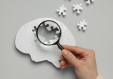 White puzzle pieces making up a brain. Several of the pieces are scattered around the table the puzzle is on, leaving a large gap in the brain. To represent that Scottish project leverages AI and RWD for early dementia diagnosis.